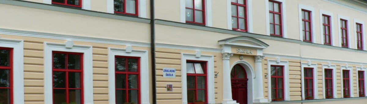 Hlavní budova školy s nápisem Škola